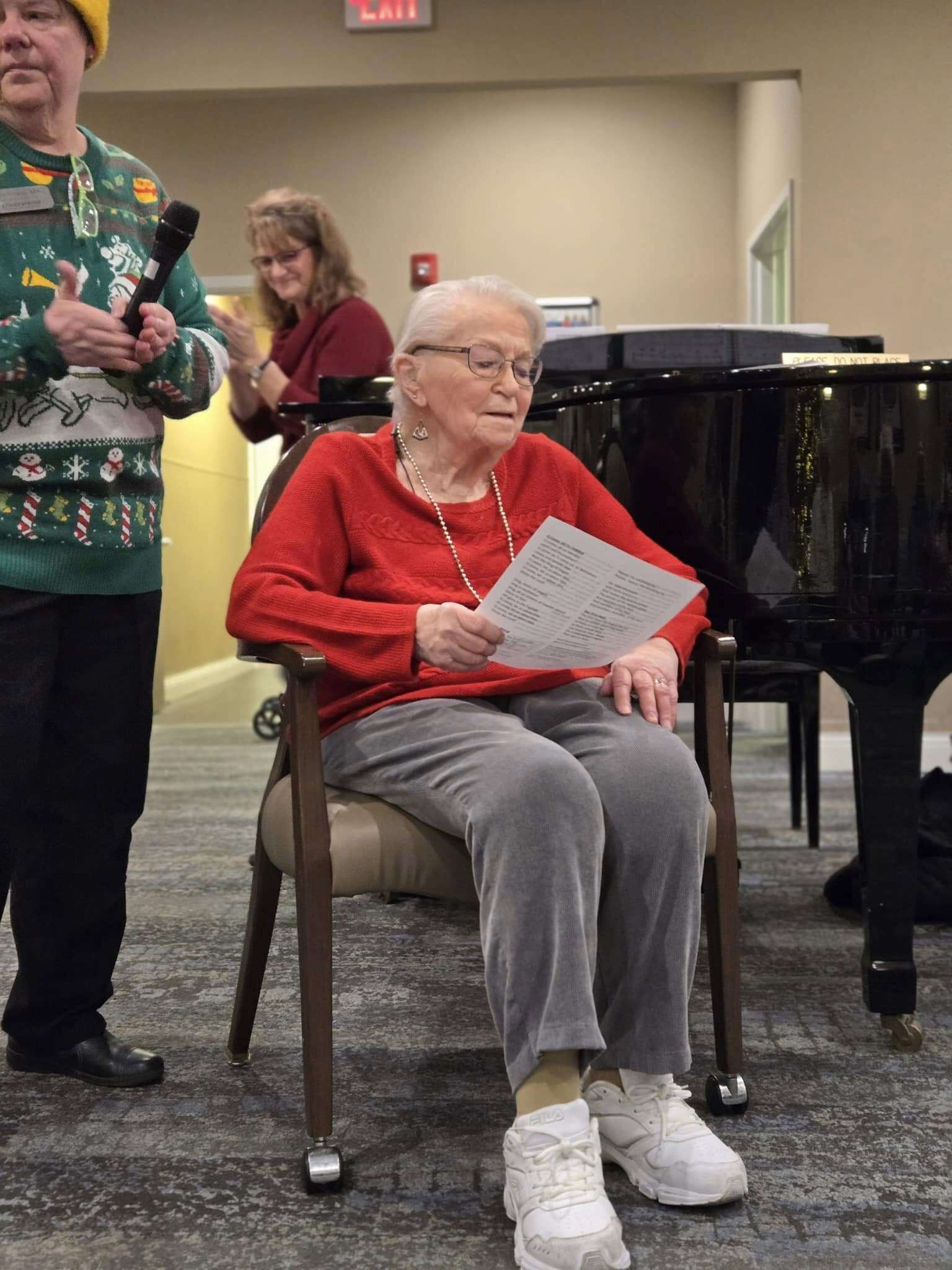 Woman in red singing Christmas carols