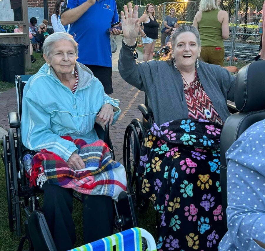 two women outdoors ready to enjoy a summer concert